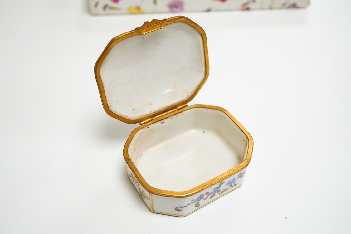 Three early 20th century French porcelain snuff boxes with floral decoration, 7cm wide